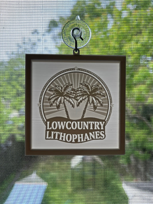 Medium hanging lithophane with the Lowcountry Lithophanes logo on a window suction cup