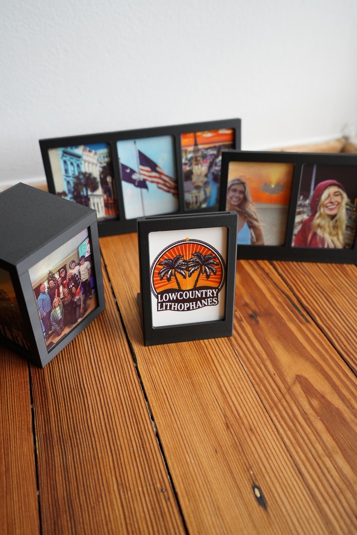 Polaroid picture frames and a Polaroid photo box displayed together on a wooden table